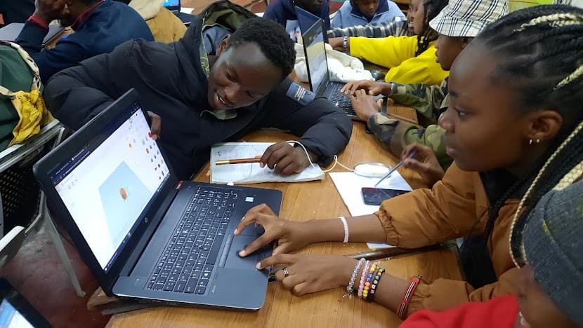 A teacher guiding a student in a design class.